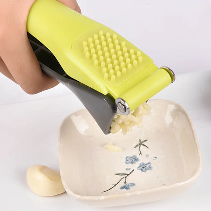 Plastic garlic masher with 4 stainless steel pressing chambers and plastic handle