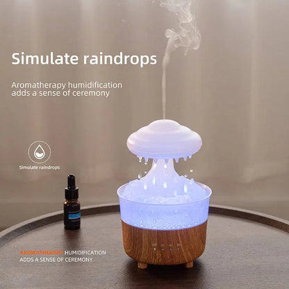 Wood grain rain cloud humidifier with LED lights and water drip feature on a table