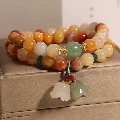 Natural green jade multi-strand bracelet with a silver-ton orchid charm for women.