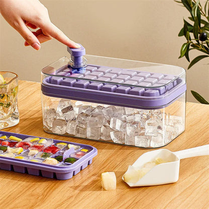 Green one-button press ice mould box with storage lid and ice shovel on kitchen counter