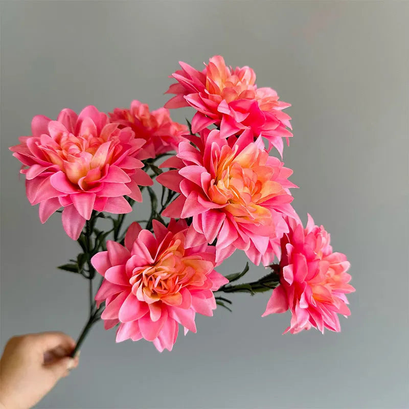 Desktop fan-shaped display holding artificial silk flowers in rose and peony varieties with colourful petals