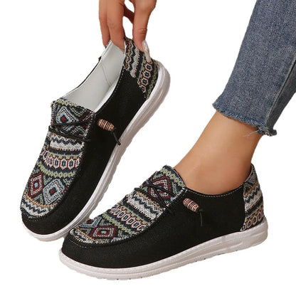 Women's black slip-on flat shoes with round toe and low-top design on a neutral background.