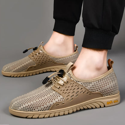 Men's black breathable mesh casual shoe with elastic band and rubber sole on a white background.