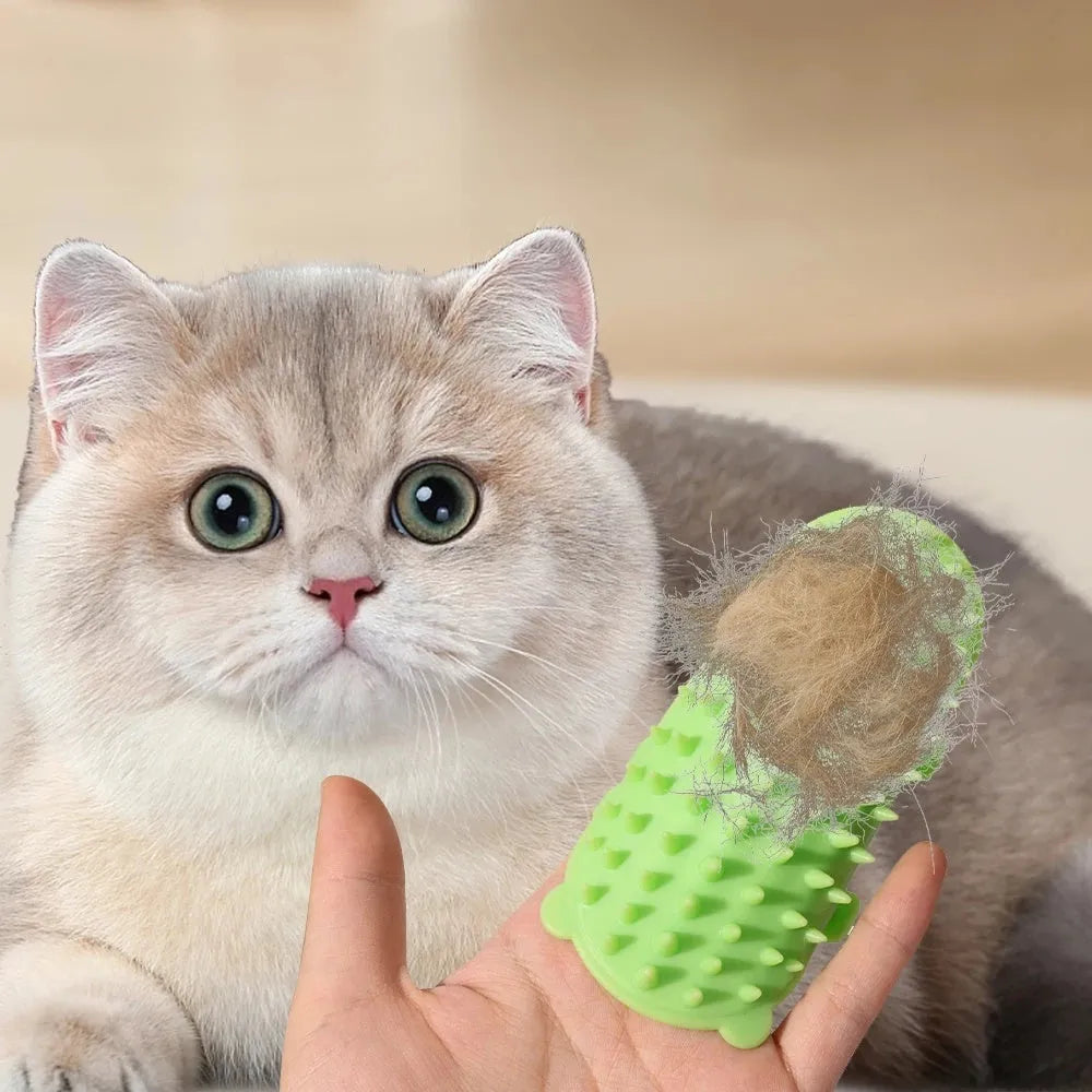 Silicone cat grooming comb with adjustable strap mounted on a table leg, shown in green.