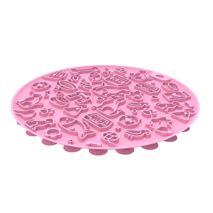 Round blue silicone pet licking mat with textured surface and a clear central suction cup, shown on a tile floor.