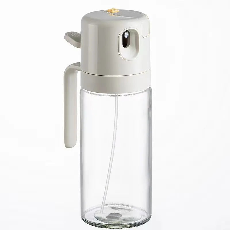 Warm grey glass oil sprayer bottle with a switchable nozzle for spray or pour modes.