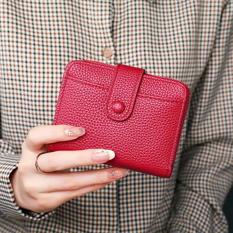 Women's solid colour PU short wallet in beige, showing lychee pattern and sewing thread detail.