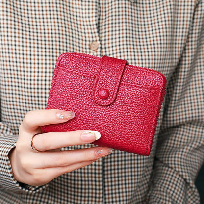 Women's solid colour PU short wallet in beige, showing lychee pattern and sewing thread detail.