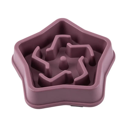 Yellow plastic slow feeding dog bowl with raised obstacles at base to prevent choking
