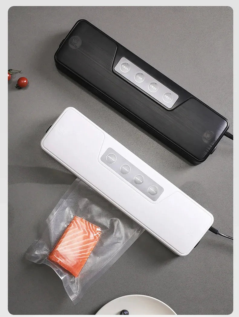 Black automatic vacuum sealer with 30cm sealing bar on kitchen counter next to vacuum-sealed food packages