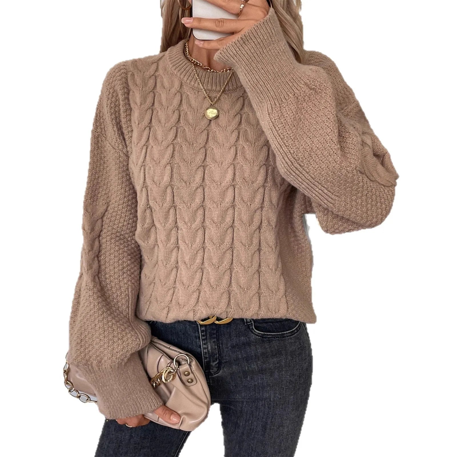 Women's beige twist knit loose sweater with round neck and regular sleeves on a hanger