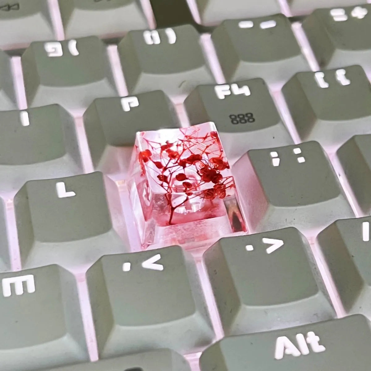 Transparent resin mechanical keyboard keycap with glitter starry sky effect in red, pink, green, or violet.