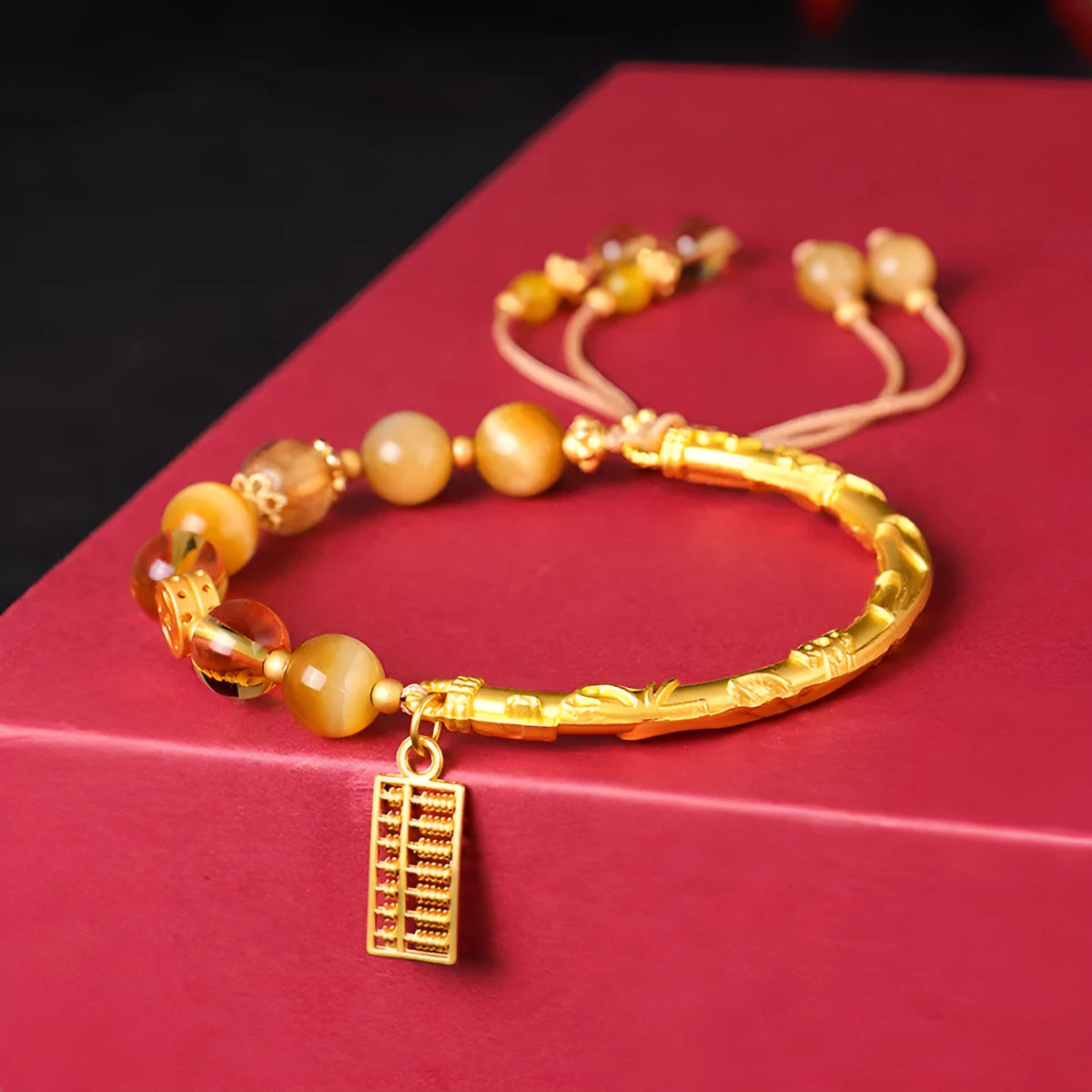 Women's handmade beaded bracelet with diamond-shaped tigereye and citrine abacus tag, yellow tower crystals, and copper details.