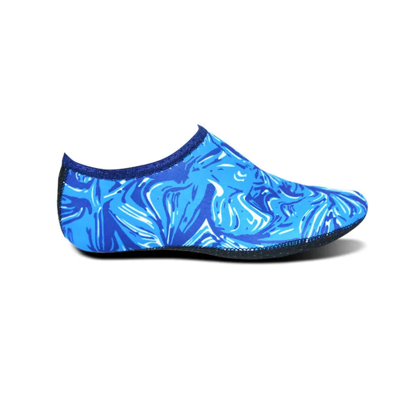 Pair of snorkeling diving socks in camouflage red, 2.5mm rubber and Lycra, non-slip sole, shown flat.