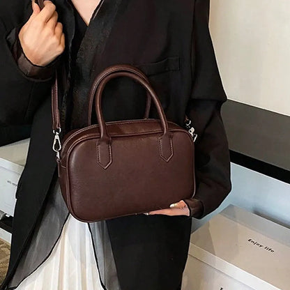 Small square retro messenger bag with single shoulder strap in black or coffee colour