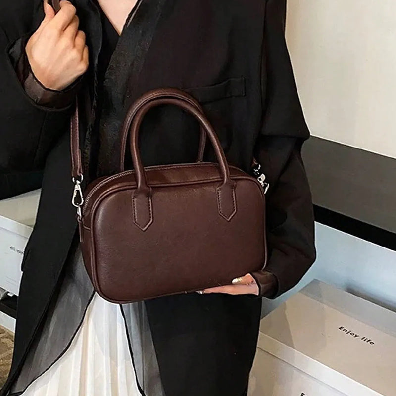 Small square retro shoulder messenger bag with single strap, PU leather construction, horizontal suitcase shape, polyester lining, available in black or coffee colour, with medium-soft hardness for everyday use