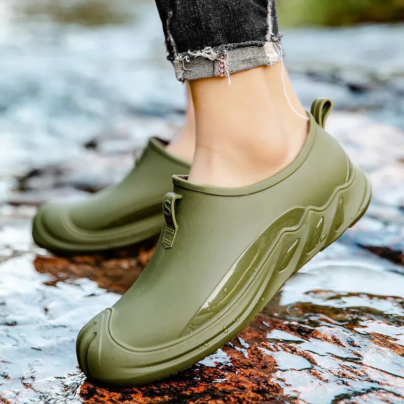 Men's short casual rain boot in solid colour, plastic upper, shown on foot.