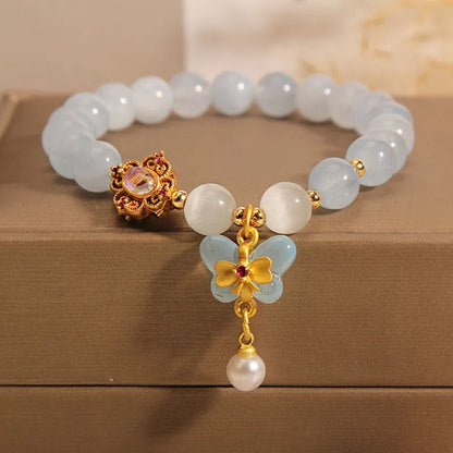 Women's crystal bracelet with a blue aquamarine butterfly pendant and rhinestone details.
