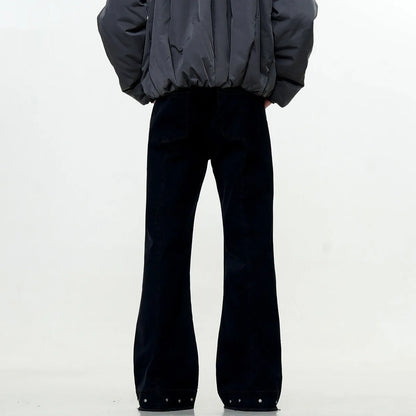 A pair of black straight-leg cotton jeans with a mid-waist fit and horn-style leg opening on a plain background.