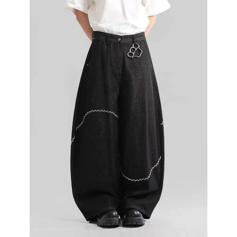 Men's black straight-leg denim trousers on a hanger, showing mid waist and zip fly detail.