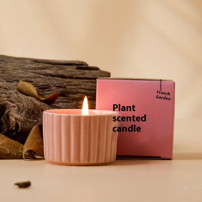 Soy wax aromatherapy candle inside a handmade ceramic cup, shown in a mint green colour.