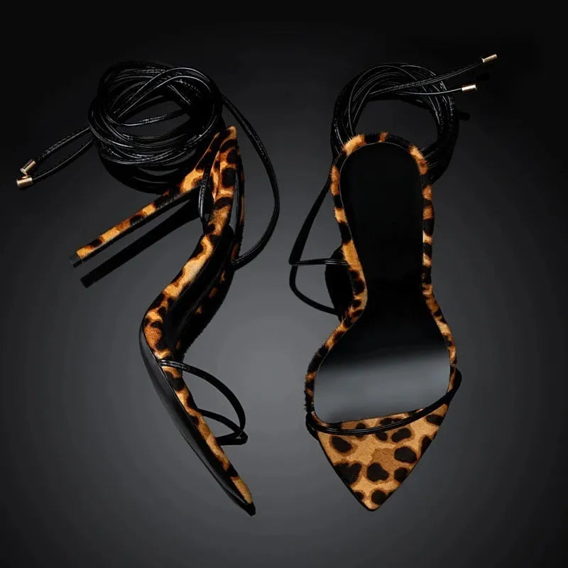 Leopard print women's Roman sandals with pointed toe and lace-up buckle closure on a rubber sole