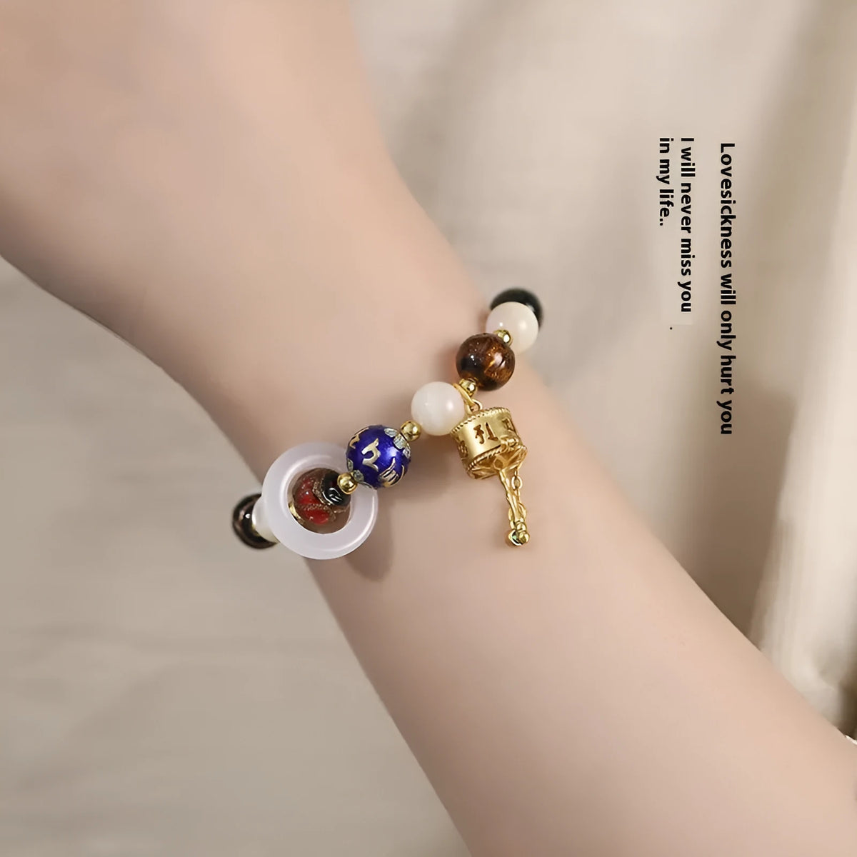 Hand-woven women's bracelet with grey coloured glaze sunstone beads and white lip shell beads