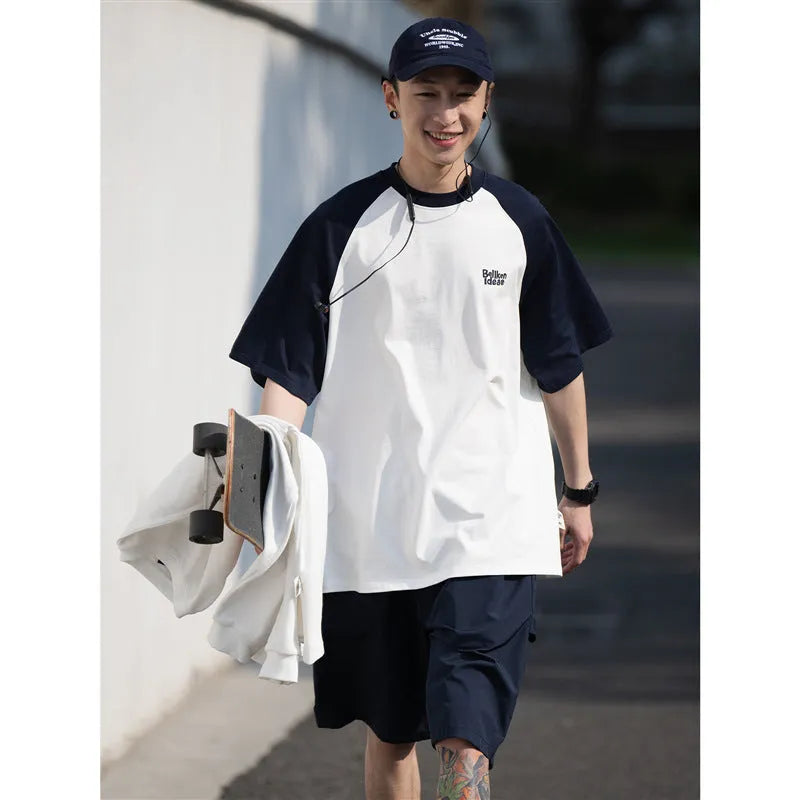 Men's blue loose-fit Japanese style long sleeve t-shirt with raglan sleeves on a hanger.