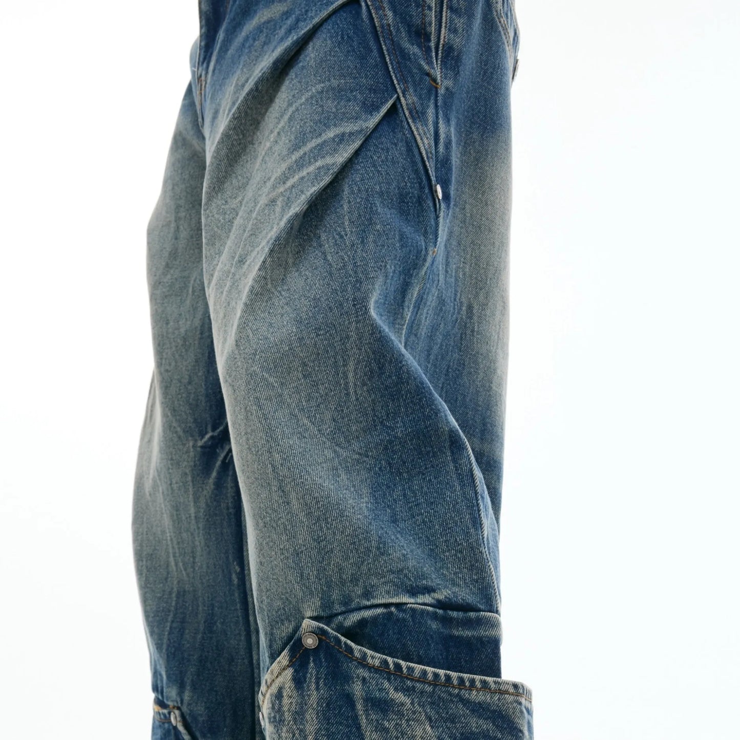 Men's verdant blue jeans with burst pattern, curved knife cut, and loose fit design