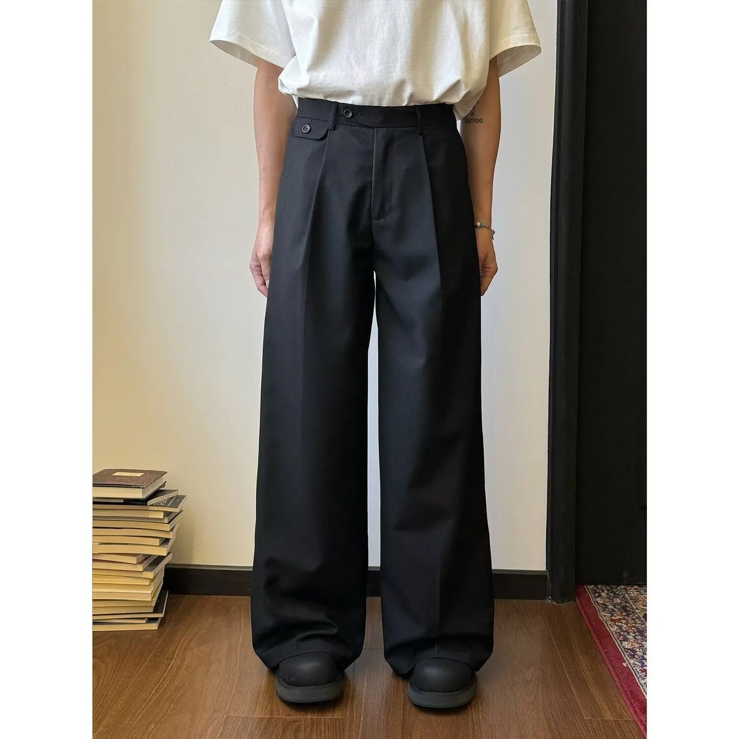 Man wearing straight-leg wide-leg casual trousers in brown, showcasing the relaxed drape and fit.
