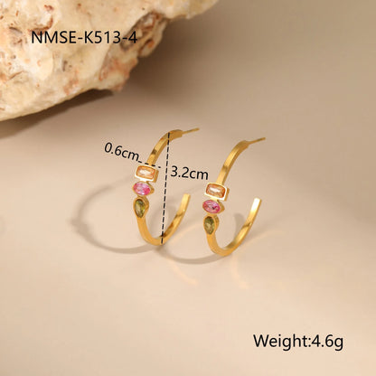 Gold geometric jewellery set with colour zircon accents showing necklace, ring, and earrings