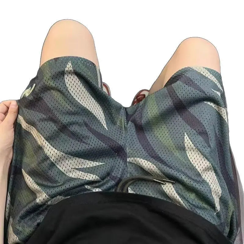 Men's camouflage patterned straight-leg mesh shorts laid flat, showing cotton blend fabric and relaxed fit.