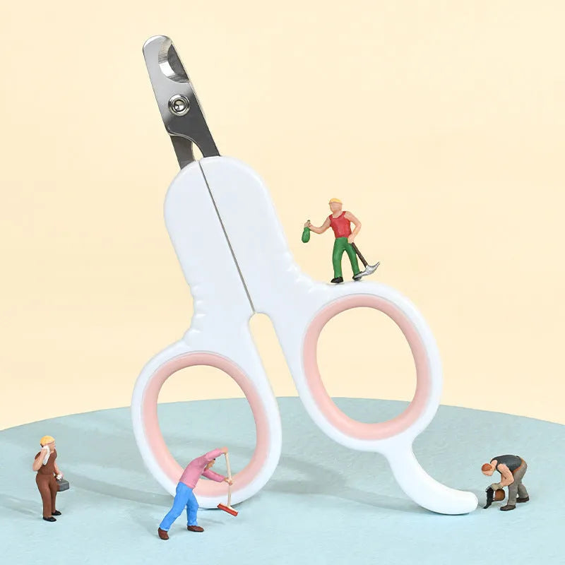 Grey and pink pet nail clippers with curved tips and a rubber-coated ergonomic handle on a table.