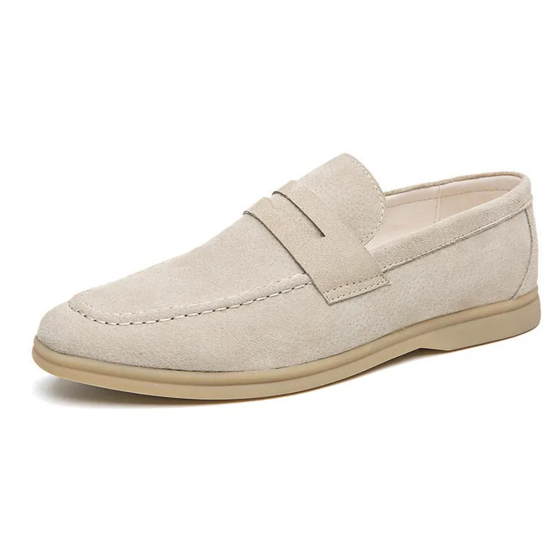 Men's beige leather slip-on shoes with a round toe and mid heel on a rubber sole.