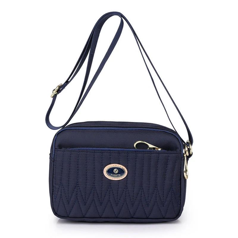 Compact nylon messenger bag for women in various colours with adjustable strap