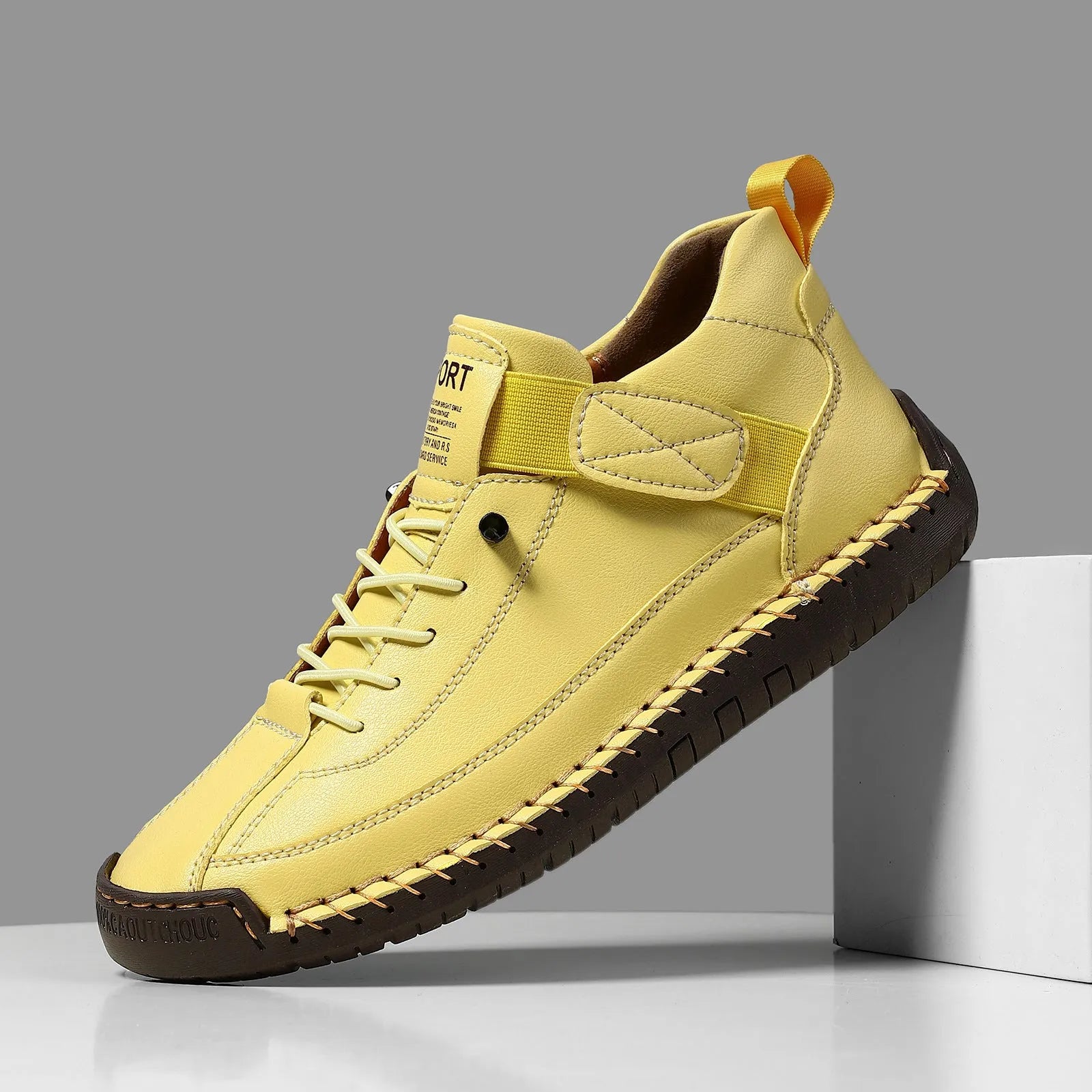 Men's black mid-top Martin boots with elastic band and sewn sole on a plain background.