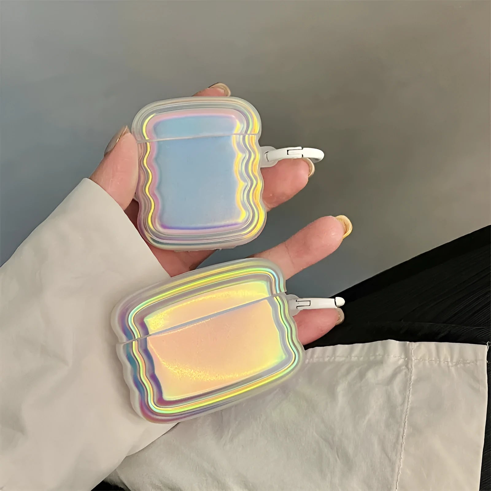 Colourful magic laser ring silicone protective case for Apple AirPods on a white background.
