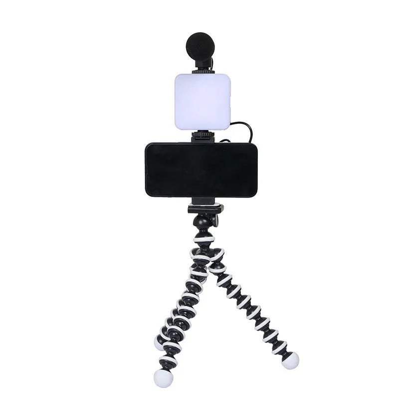 Square LED camera flash with universal hot shoe mount and rotatable head, shown with optional octopus stand tripod.