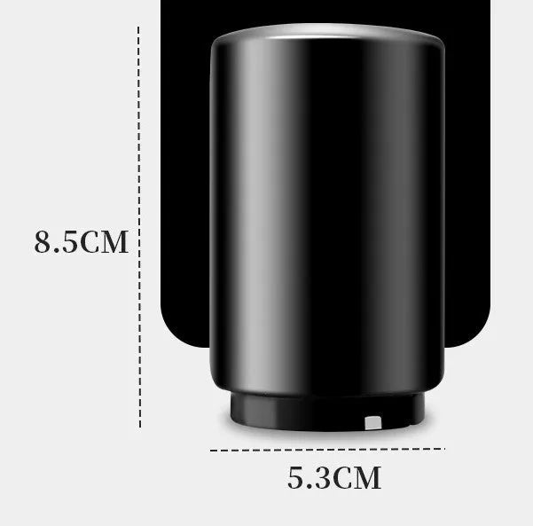 Stainless steel automatic bottle opener measuring 8.4 cm by 5.3 cm on a kitchen counter