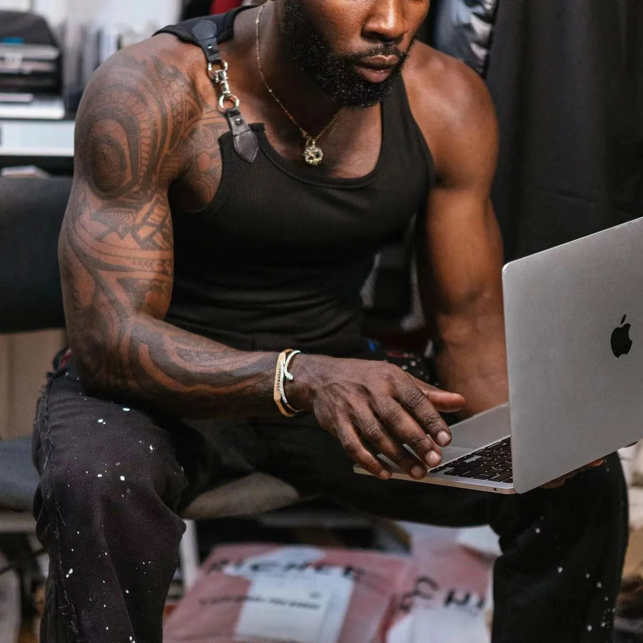 A sleeveless tight-fit vest in a solid colour, shown in either white or black.