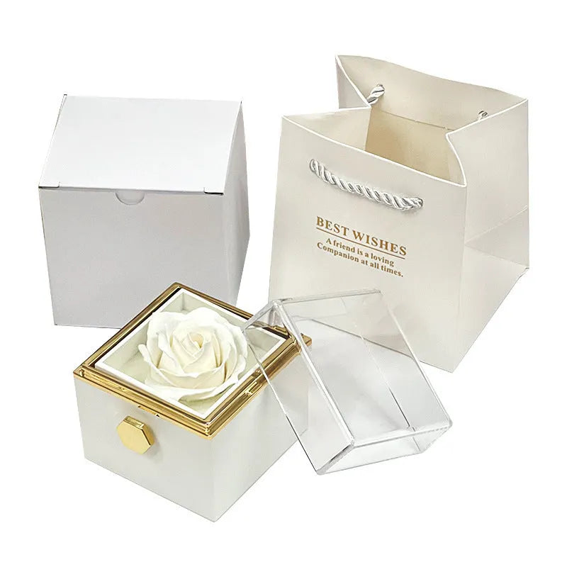 Rotating rose jewellery gift box with a preserved red rose under a clear acrylic dome, showing the interior rotating drawer.