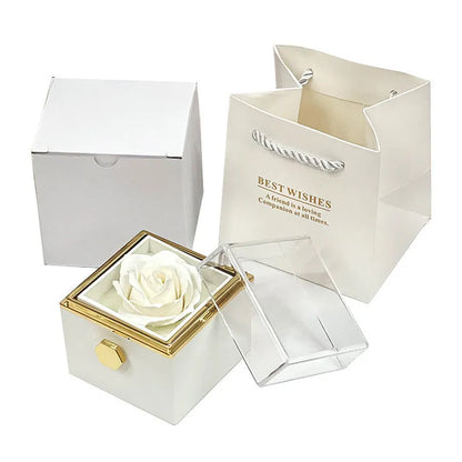 Rotating rose jewellery gift box with a preserved red rose under a clear acrylic dome, showing the interior rotating drawer.