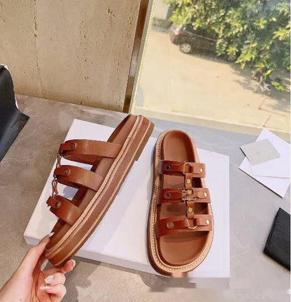 Women's white Roman sandal slippers with sheepskin upper and patent leather straps.
