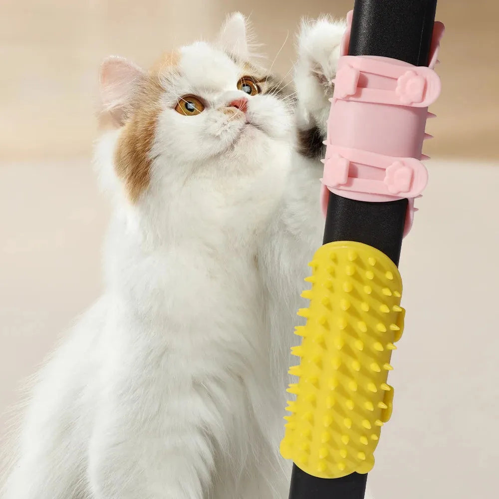 Silicone cat grooming comb with adjustable strap mounted on a table leg, shown in green.