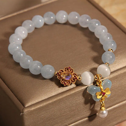 Women's crystal bracelet with a blue aquamarine butterfly pendant and rhinestone details.