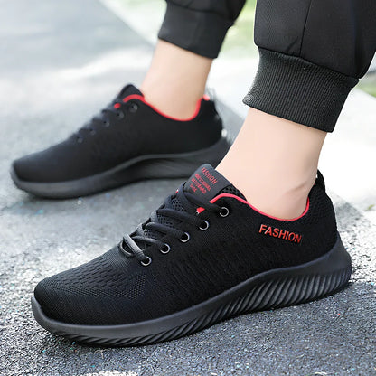 Men's black mesh sports shoes with red accent details and flexible PVC sole construction