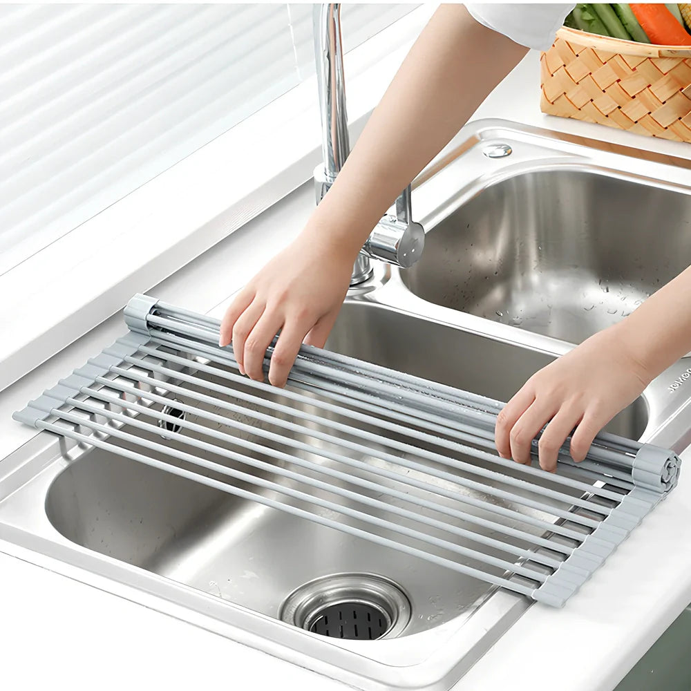 Stainless steel sink drain rack with rolling curtain design folded to show compact 5cm storage thickness