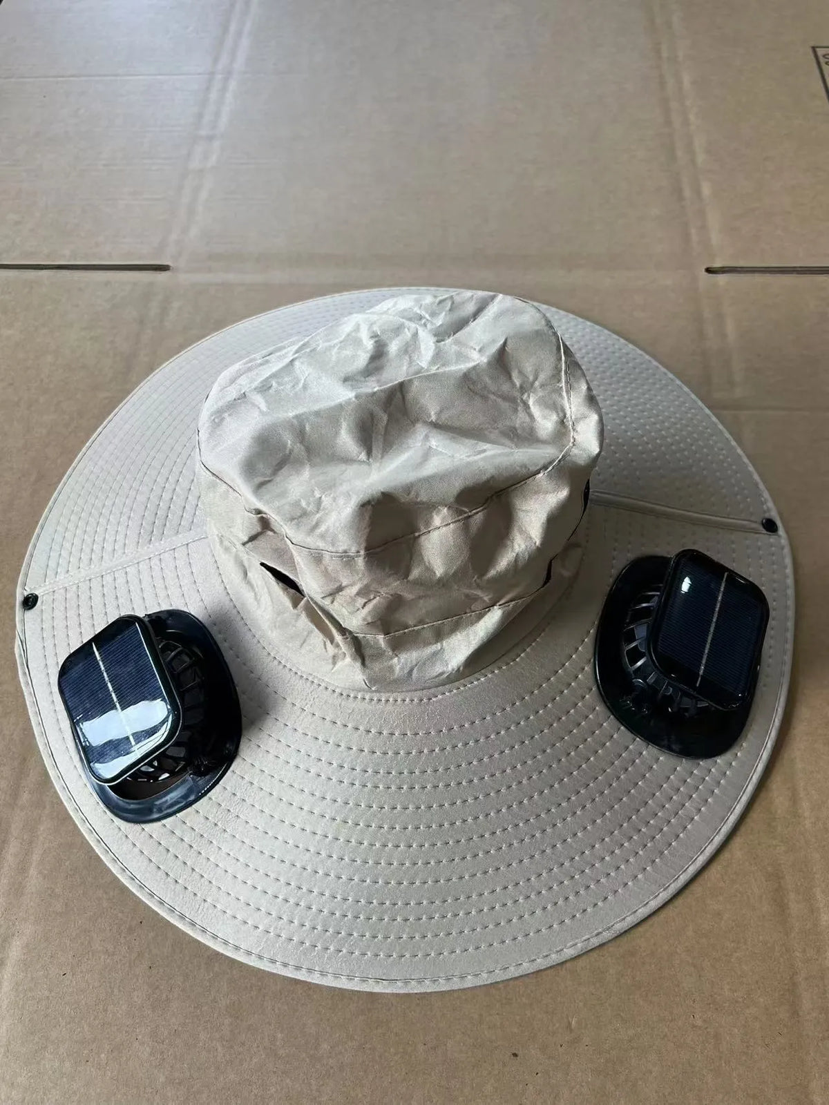 Men's grey solar fan cap with large peak and integrated cooling fans on the front.