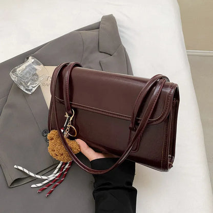 Brown women's square shoulder bag with double straps and pendant accessory