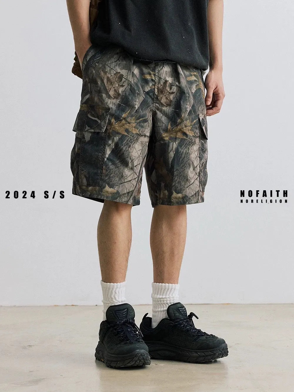 Women's loose fit denim shorts in army green colour, showing straight-leg cut and zip placket.